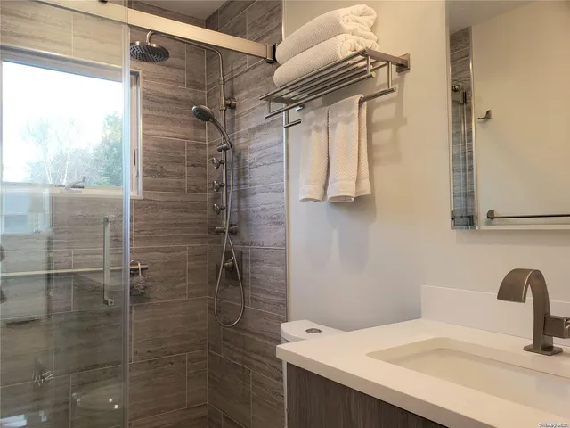 a street sign on a wall next to a road