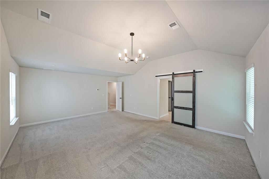 4450 Richmond Court Stone Mountain, GA 30083 - Photo 15 of 31 wooden floor in an empty room with a window