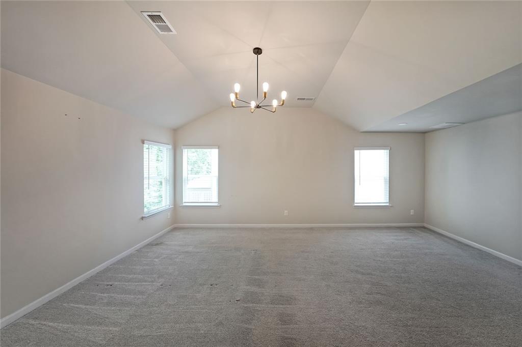 4450 Richmond Court Stone Mountain, GA 30083 - Photo 17 of 31 wooden floor in an empty room with a window