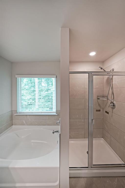 4450 Richmond Court Stone Mountain, GA 30083 - Photo 19 of 31 a bathroom with a bathtub and a shower