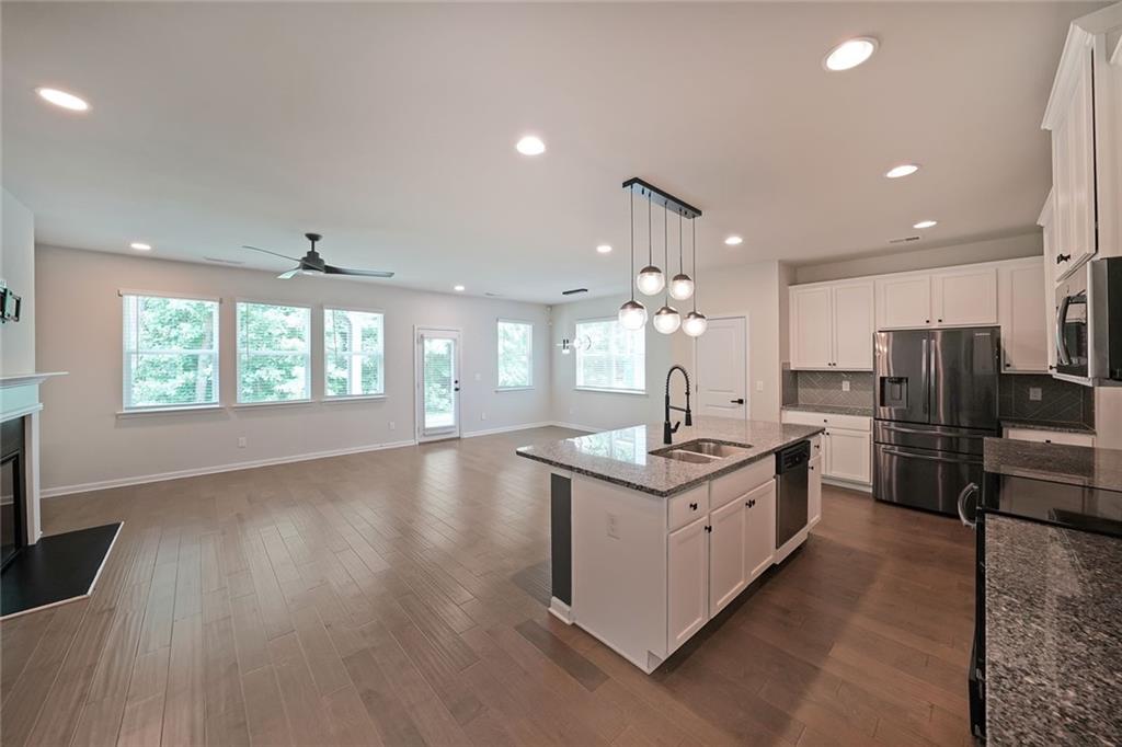 4450 Richmond Court Stone Mountain, GA 30083 - Photo 3 of 31 a kitchen with stainless steel appliances granite countertop a sink stove and refrigerator