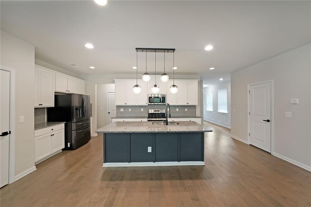4450 Richmond Court Stone Mountain, GA 30083 - Photo 9 of 31 a view of kitchen with cabinets microwave and stove