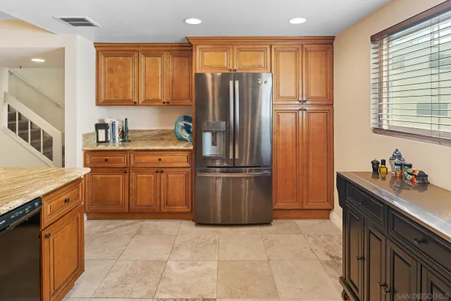 a bathroom with a granite countertop toilet sink and mirror
