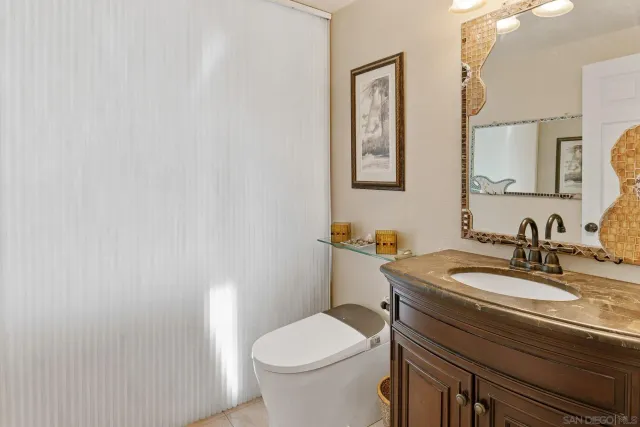 a bathroom with a toilet a sink and mirror