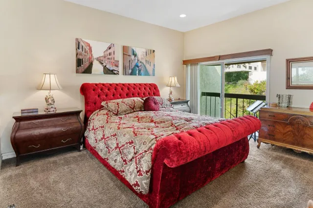 a bedroom with a large bed and a large window