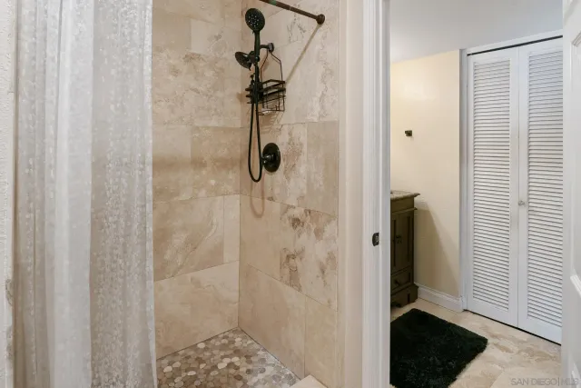 a bedroom with a bed chandelier and a window
