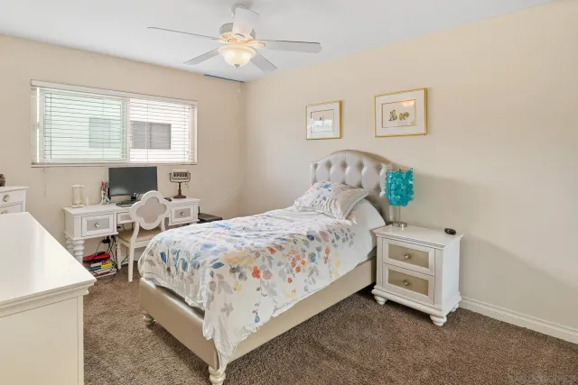 a bedroom with a bed a mirror and a table