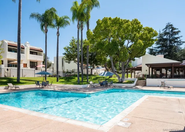 a backyard of a house with a table and chair