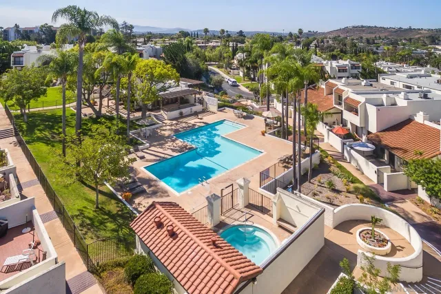 a living room with furniture dining table wooden floor and a large window