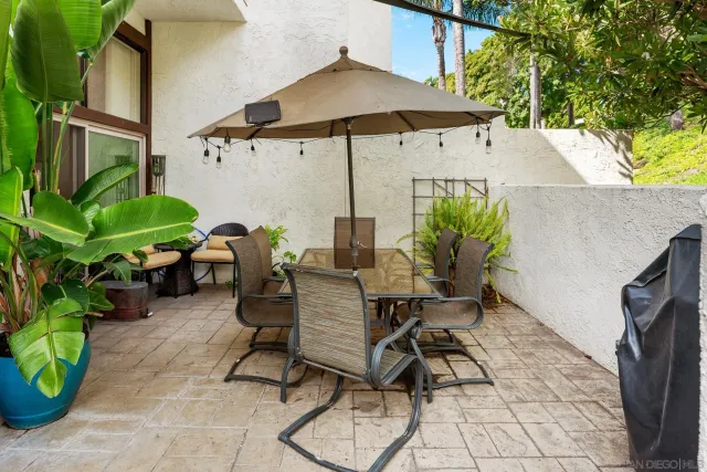 a backyard of a house with table and chairs