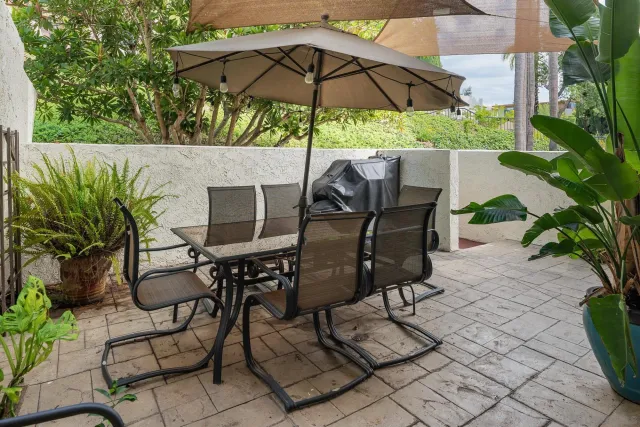 a patio with a patio table and chairs