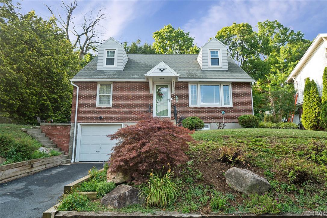 a front view of house with yard and green space