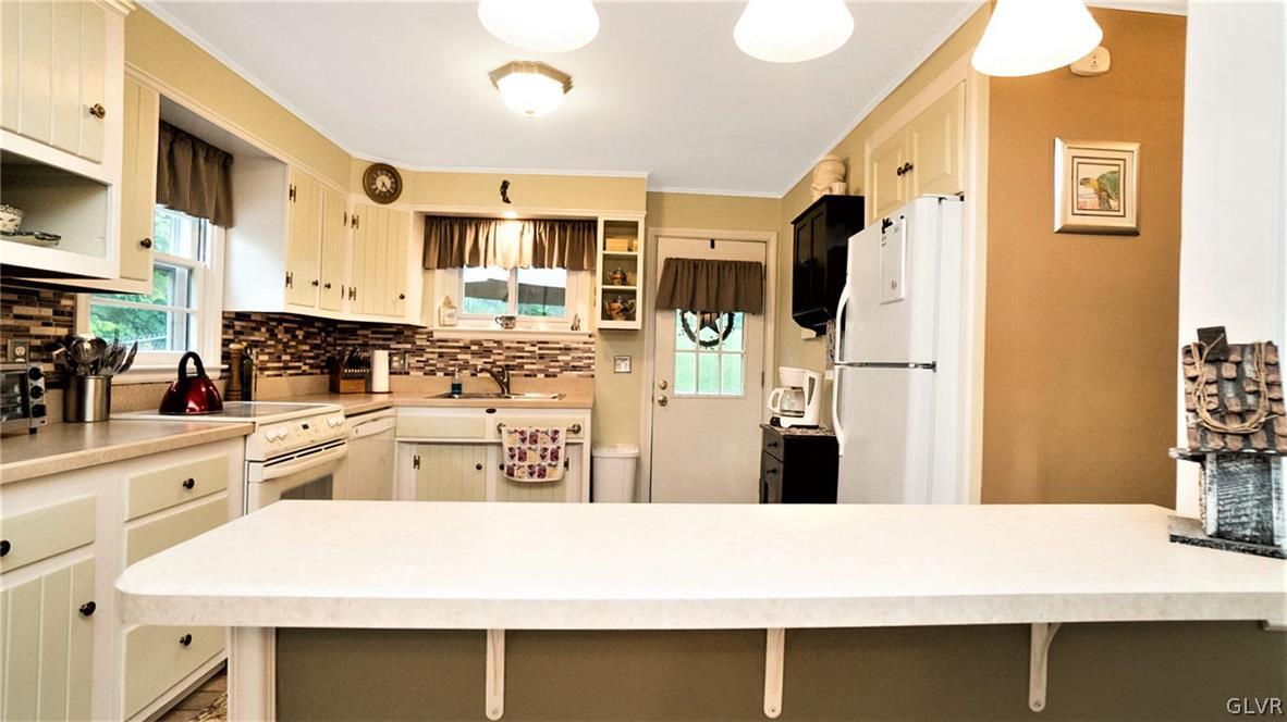 2341 Highland Street Reading, PA 19609 - Photo 11 of 36 a kitchen with stainless steel appliances a refrigerator a sink and white cabinets