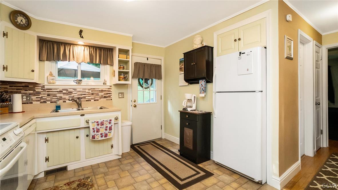 2341 Highland Street Reading, PA 19609 - Photo 10 of 36 a kitchen with stainless steel appliances a refrigerator sink and stove