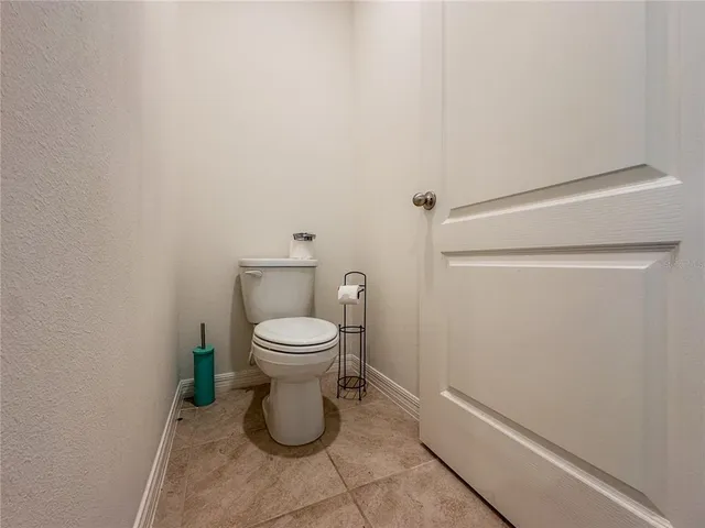 a white toilet sitting next to a shower