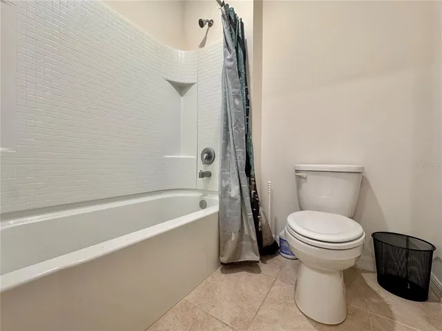 a bathroom with a toilet and a bathtub
