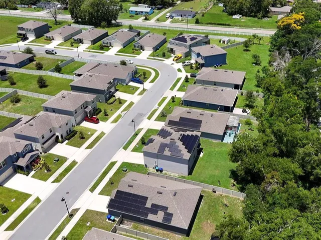 an aerial view of a house with a swimming pool yard and outdoor seating
