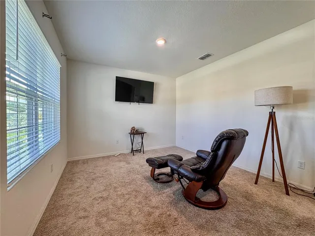 a room with furniture and a flat screen tv