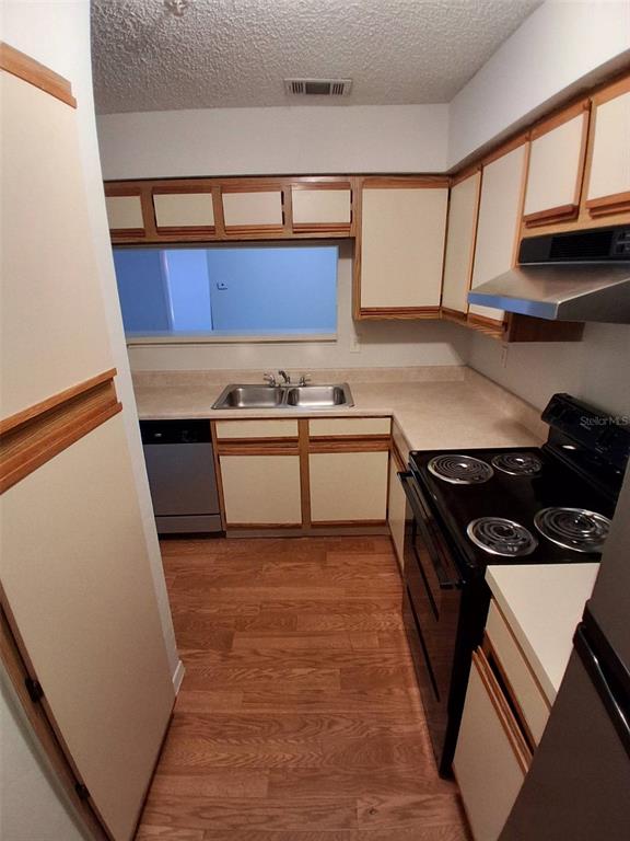 208 Afton Square, Unit 201 Altamonte Springs, FL 32714 - Photo 11 of 38 a kitchen with a sink a stove and cabinets