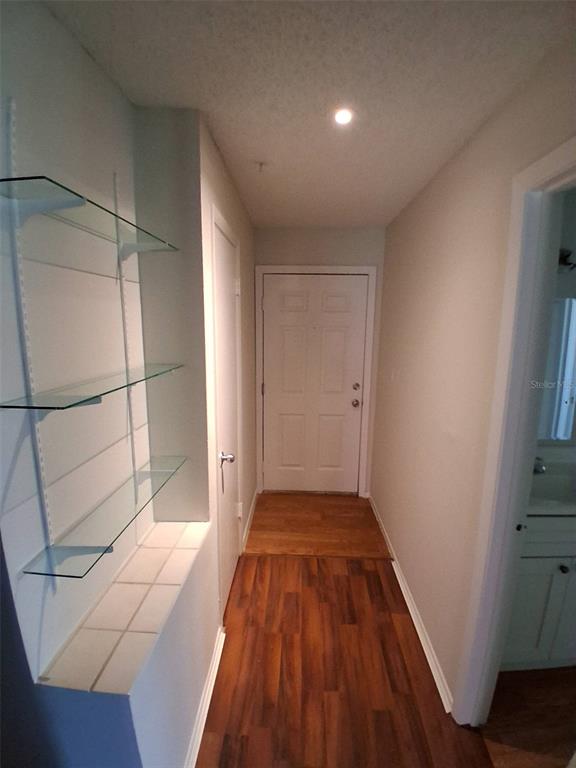 208 Afton Square, Unit 201 Altamonte Springs, FL 32714 - Photo 14 of 38 a view of an empty room with wooden floor and a window