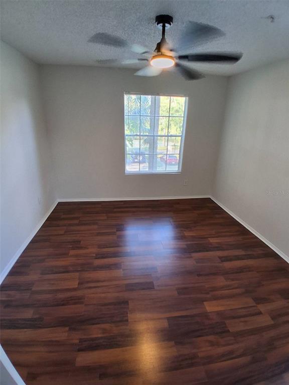 208 Afton Square, Unit 201 Altamonte Springs, FL 32714 - Photo 15 of 38 an empty room with wooden floor chandelier fan and windows