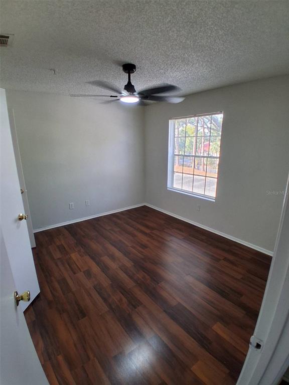 208 Afton Square, Unit 201 Altamonte Springs, FL 32714 - Photo 18 of 38 wooden floor in an empty room with a window