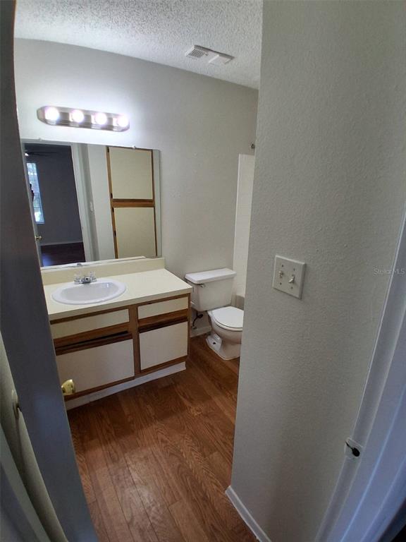 208 Afton Square, Unit 201 Altamonte Springs, FL 32714 - Photo 19 of 38 a bedroom with a bed and a mirror on dresser