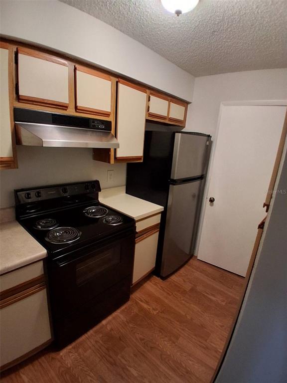 208 Afton Square, Unit 201 Altamonte Springs, FL 32714 - Photo 10 of 38 a kitchen with a stove and a refrigerator
