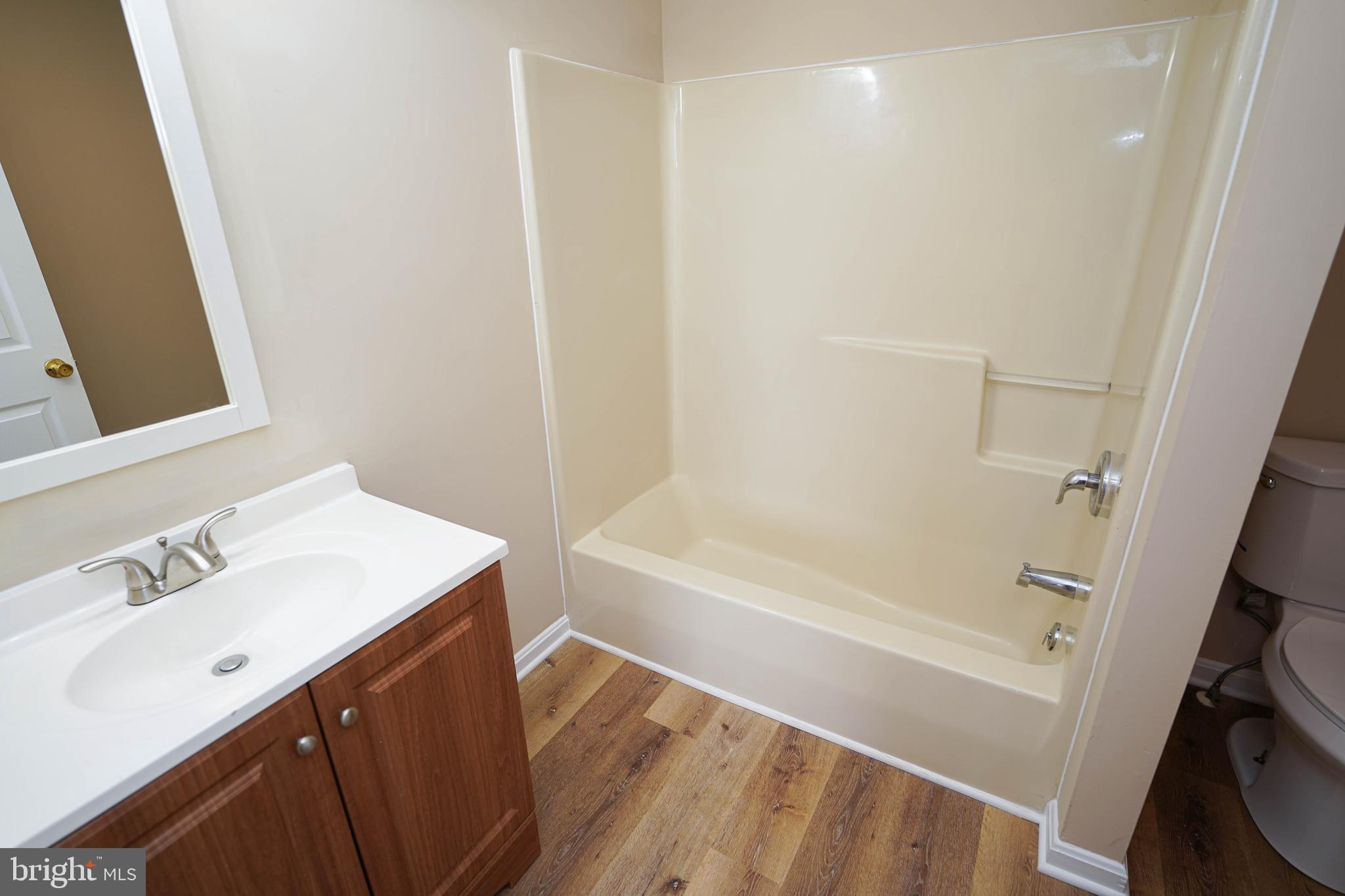 7526 Bethel Road Willards, MD 21874 - Photo 25 of 34 a bathroom with a sink a mirror and a bathtub