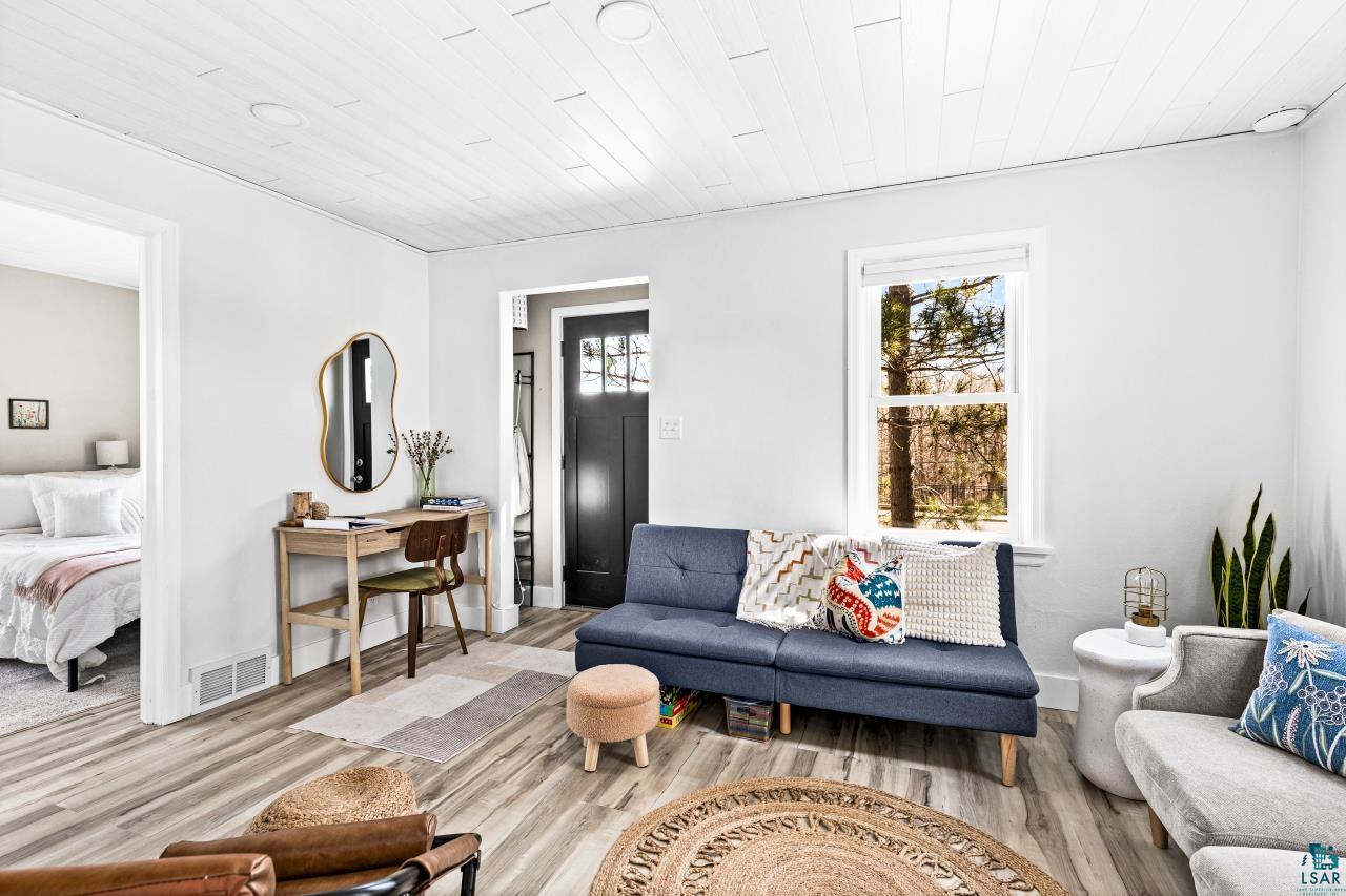 3645 Haines Road Hermantown, MN 55811 - Photo 18 of 35 Bright living area featuring wood-finish flooring, white shiplap ceiling, and a prominent window