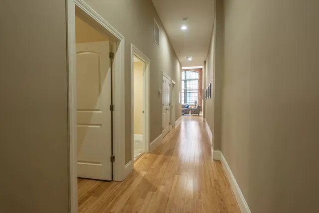 a view of hallway with wooden floor