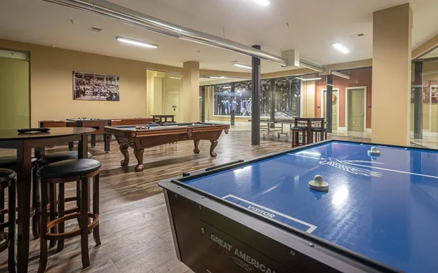 a living room with furniture pool table and a large window