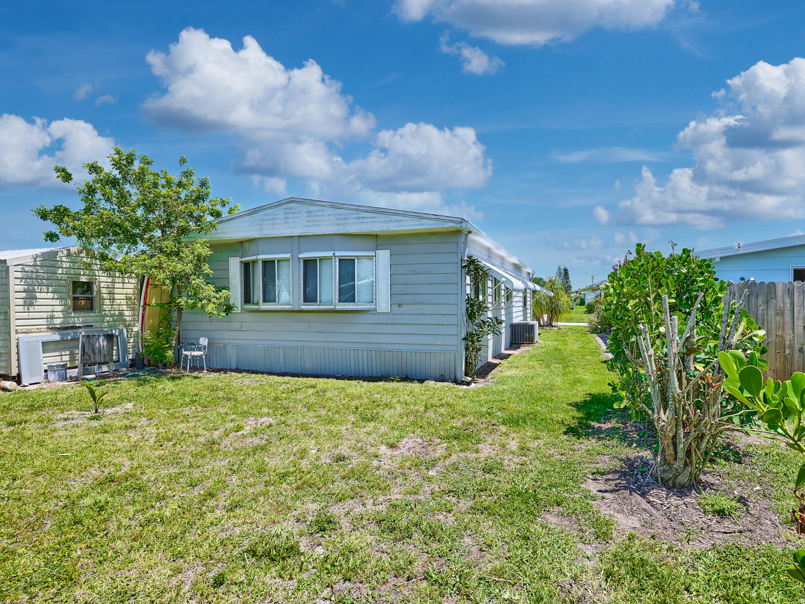 6977 Southeast Delegate Street Hobe Sound, FL 33455 - Photo 48 of 60 a house view with a garden space