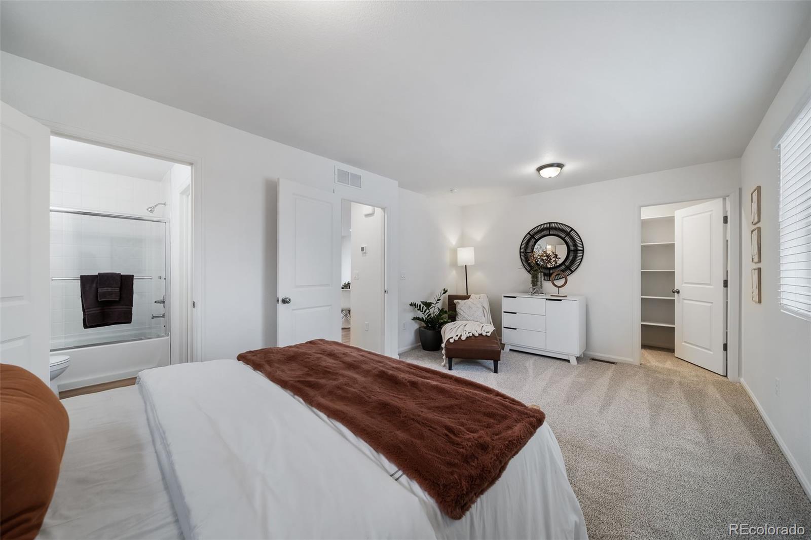 3372 Baltin Road Johnstown, CO 80534 - Photo 16 of 24 a bedroom with a large bed and a flat screen tv