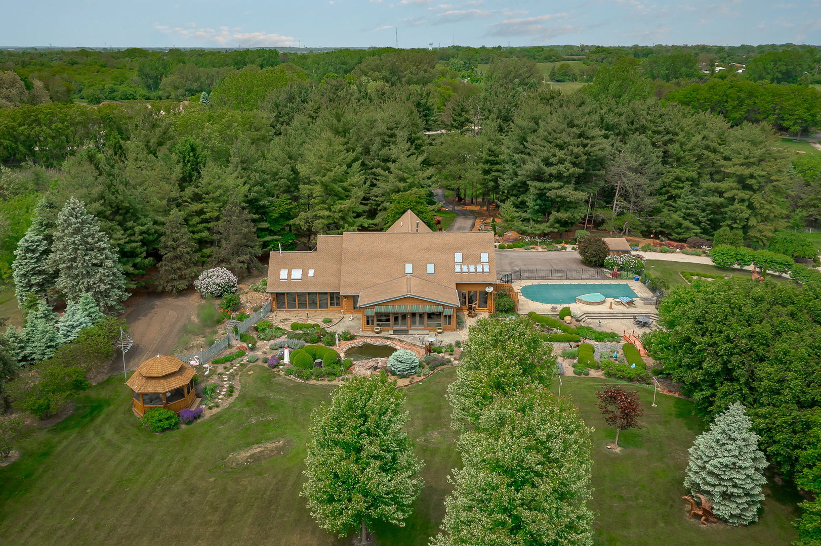 an aerial view of a house with garden space and street view
