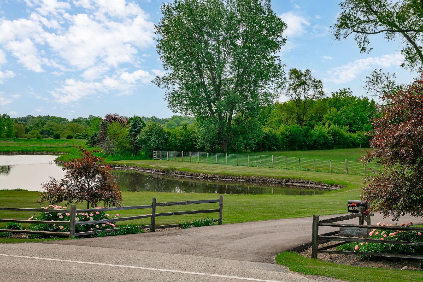 29295 North Callahan Road Wauconda, IL 60084 - Photo 5 of 45 a view of a lake with a garden and trees