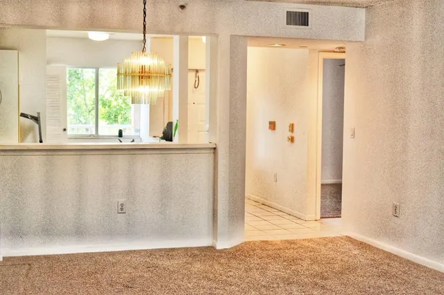 a view of a kitchen with wooden floor and windows