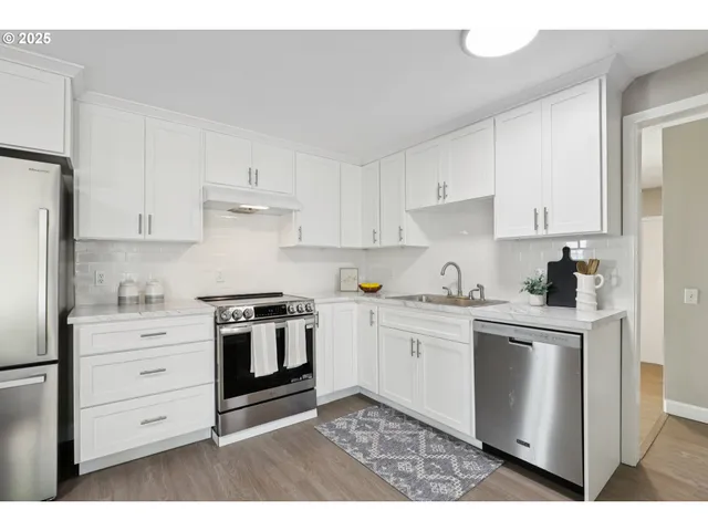 a kitchen with granite countertop a stove top oven sink and cabinets