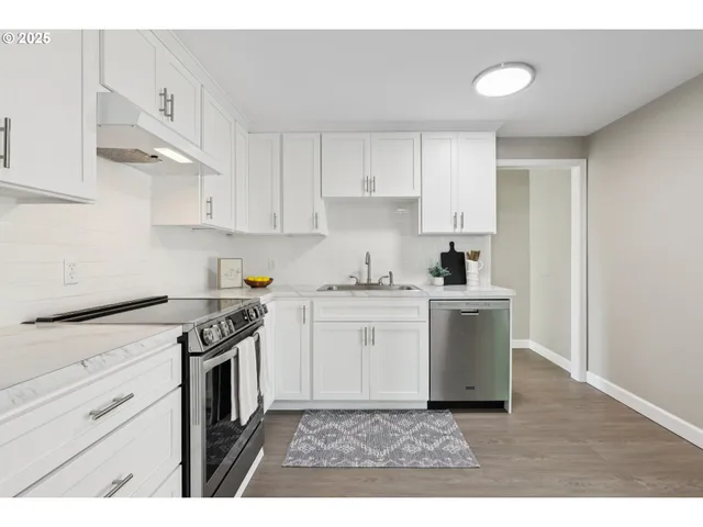 a kitchen with a stove top oven sink and cabinets
