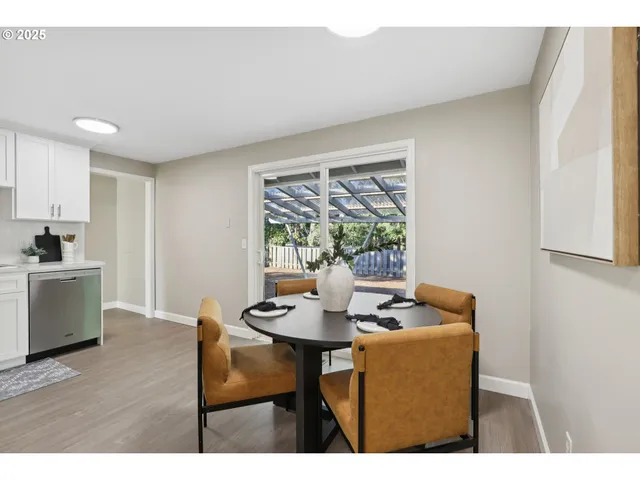 a dining room with furniture and wooden floor