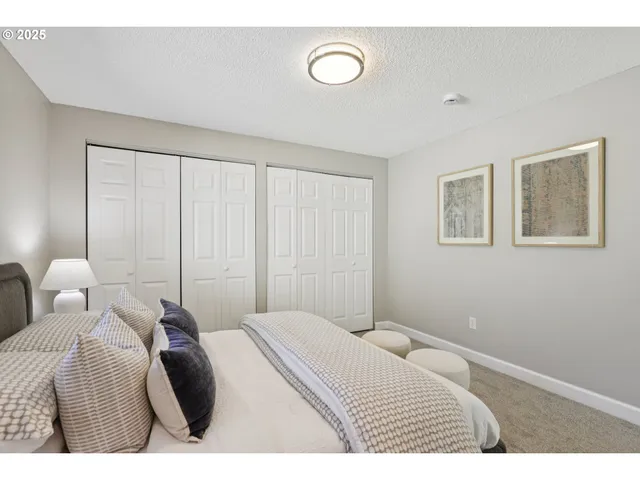 a bedroom with a bed and a painting