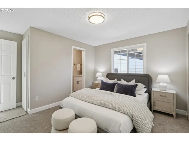 a bedroom with a bed and a night stand