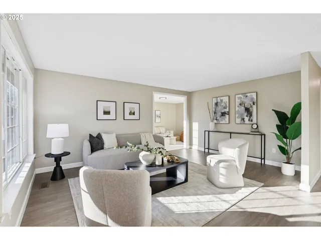 a living room with furniture and a potted plant