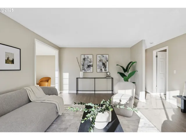 a living room with furniture and a potted plant