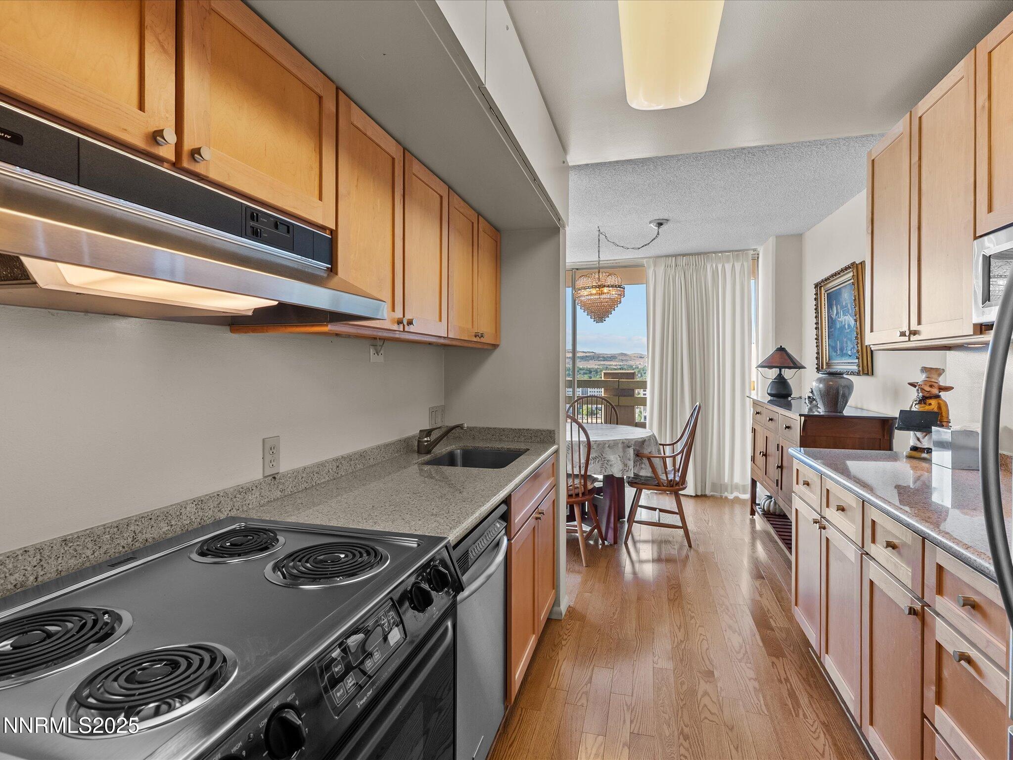 100 North Arlington Avenue, Unit 20J Reno, NV 89501 - Photo 4 of 17 a kitchen with a stove and a sink