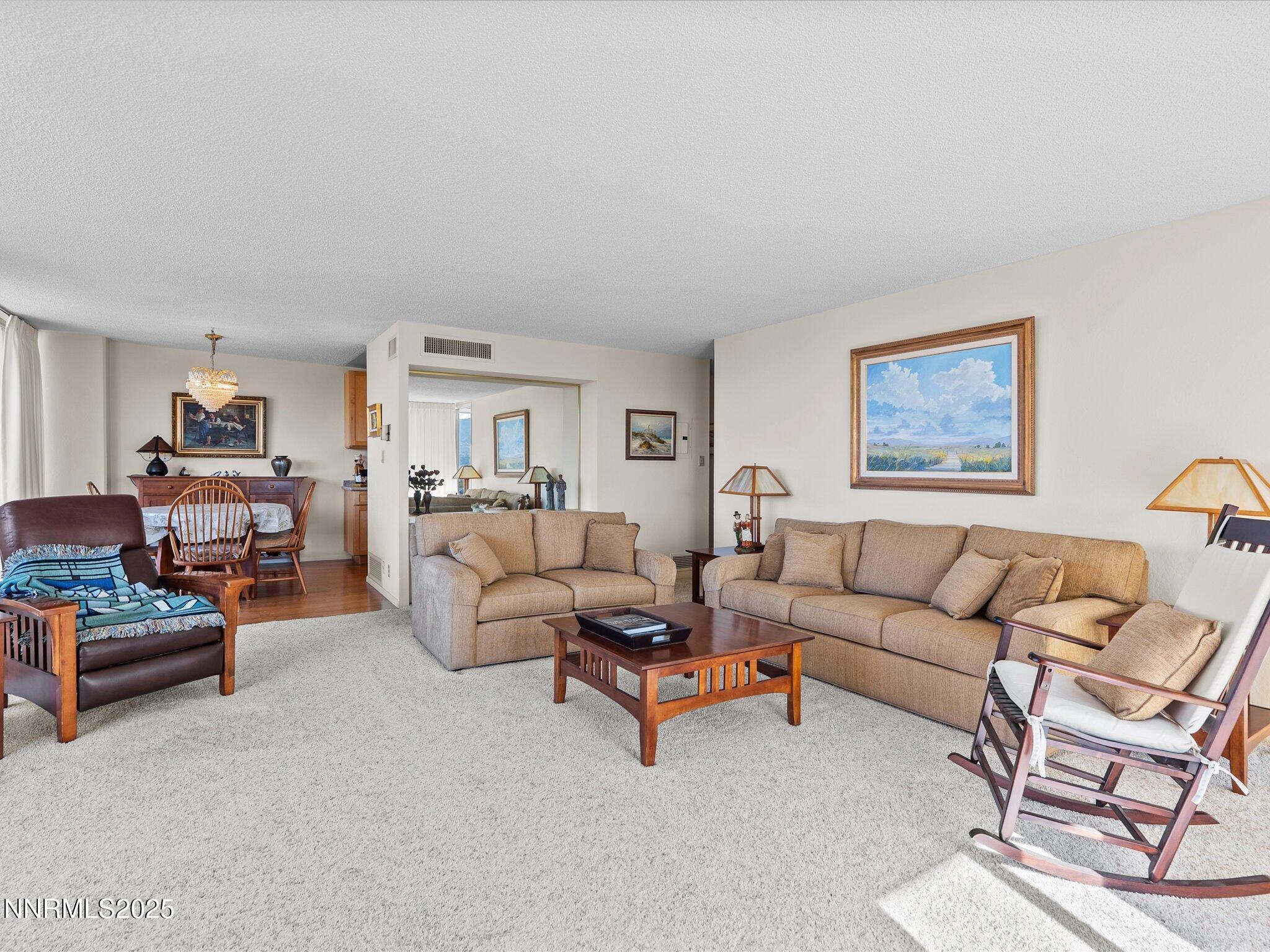 100 North Arlington Avenue, Unit 20J Reno, NV 89501 - Photo 8 of 17 a living room with furniture and a couch