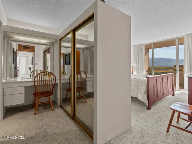 a bathroom with a granite countertop toilet sink and mirror