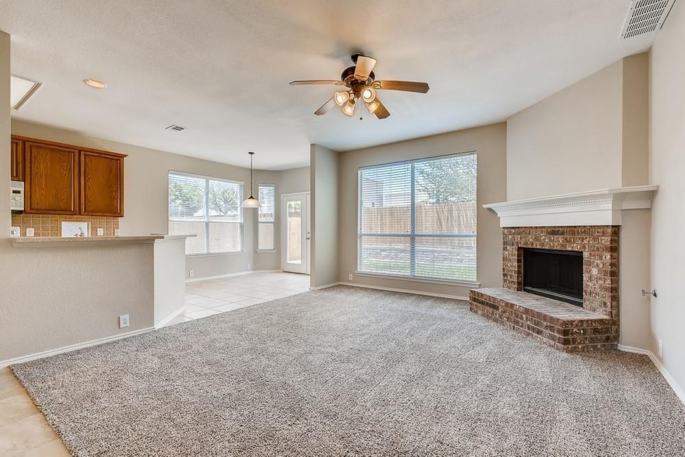 9937 Appletree Way Fort Worth, TX 76244 - Photo 13 of 25 a view of an empty room with a fireplace and a window