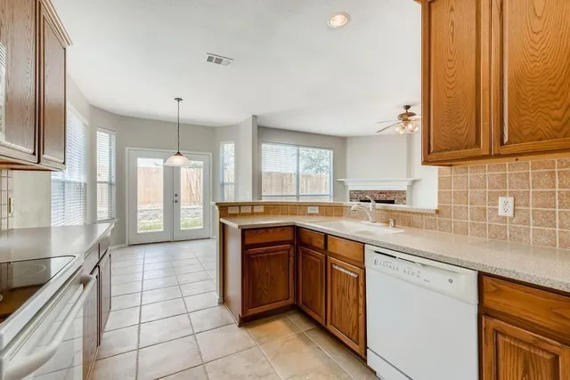 a kitchen with a sink a stove and cabinets