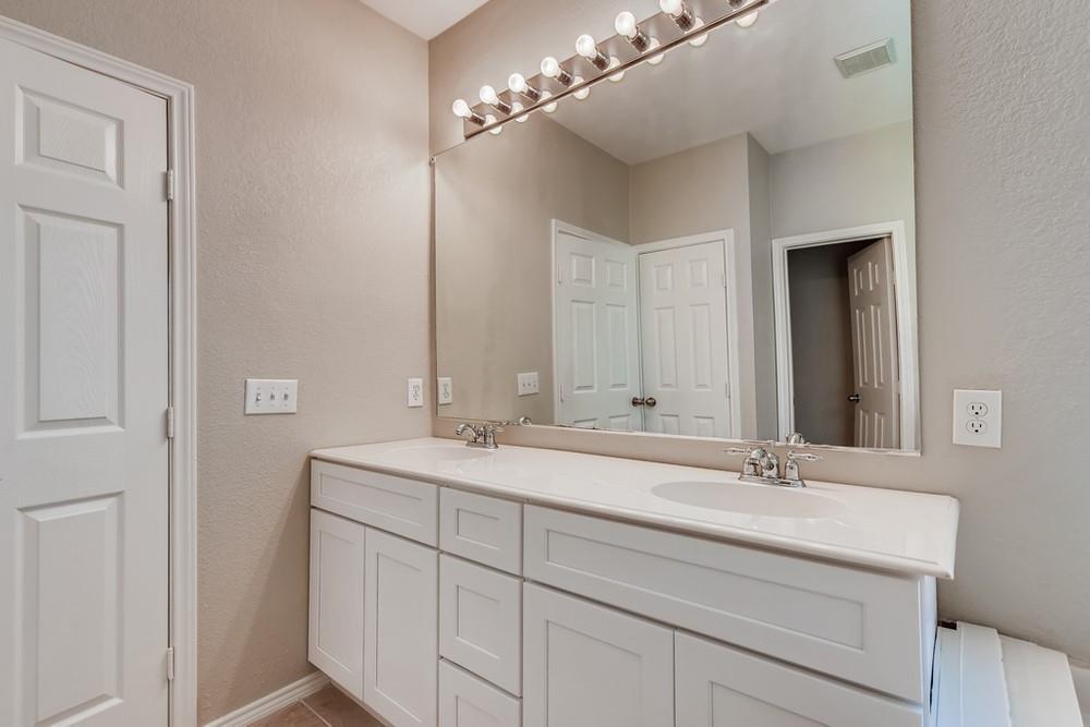 9937 Appletree Way Fort Worth, TX 76244 - Photo 20 of 25 a bathroom with a double vanity sink and a mirror